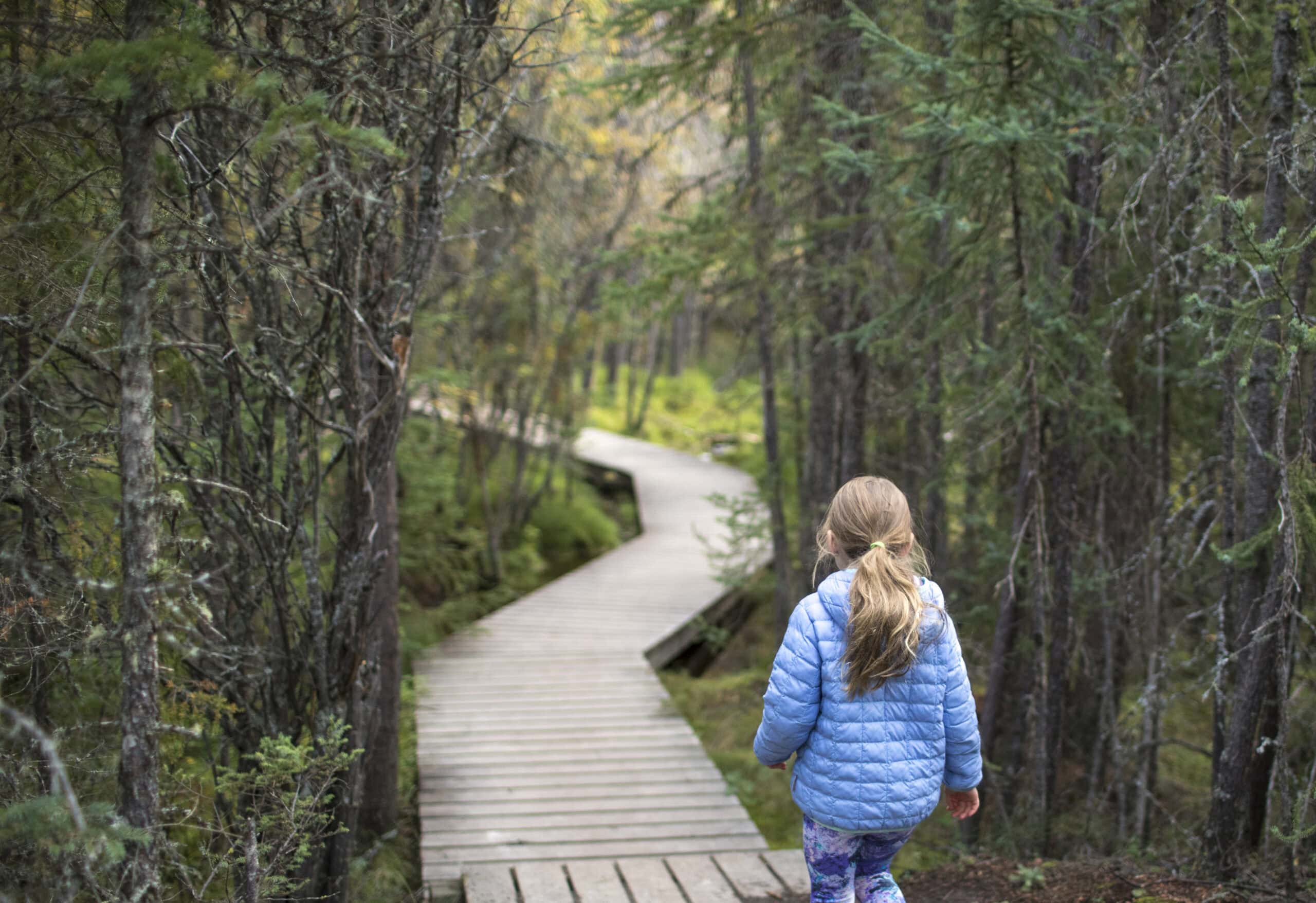 Girl walking on the Cameron Lake Broadwalk.